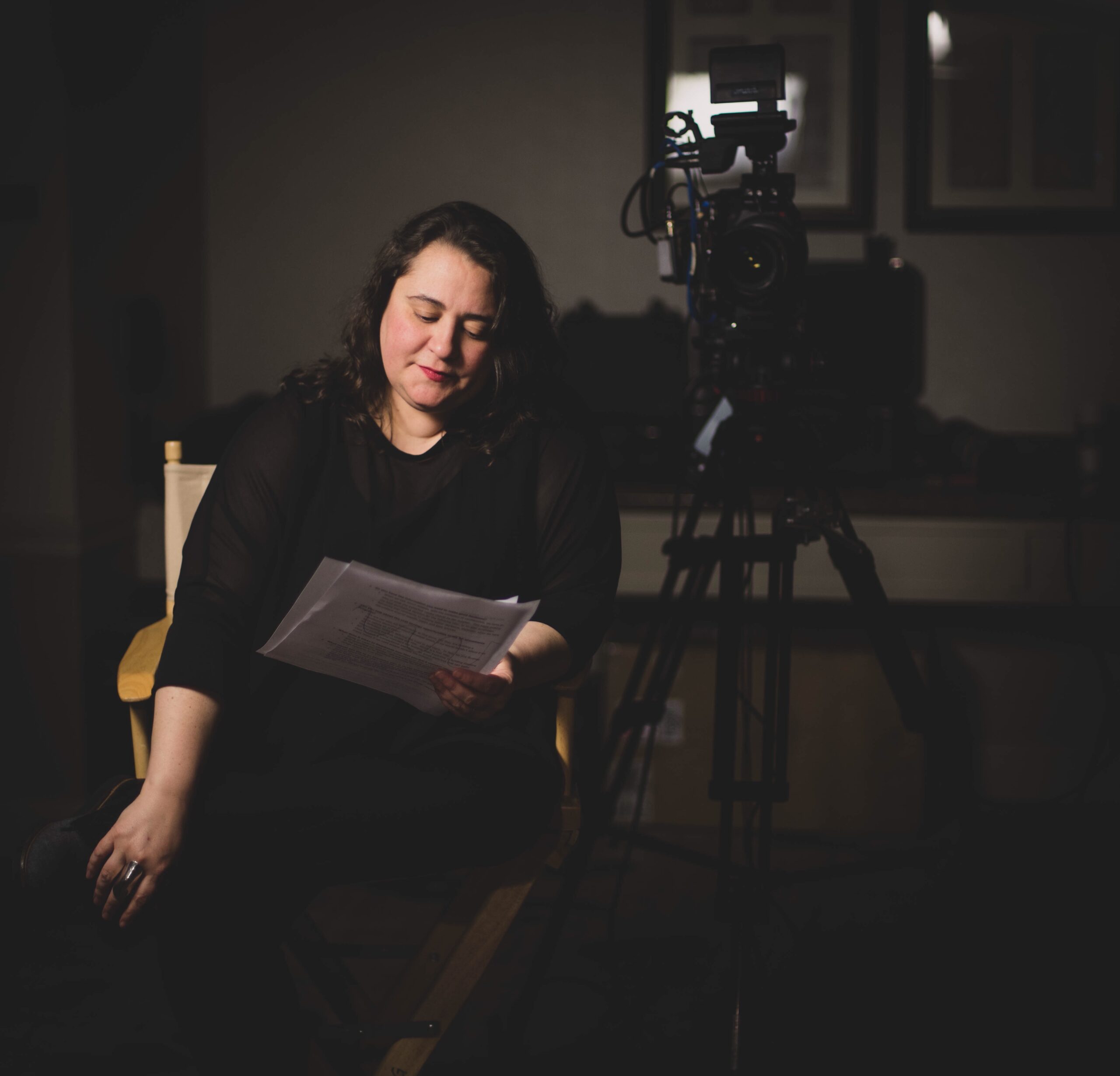 Nonprofit spokesperson preparing for a press interview with camera and notes during media training session