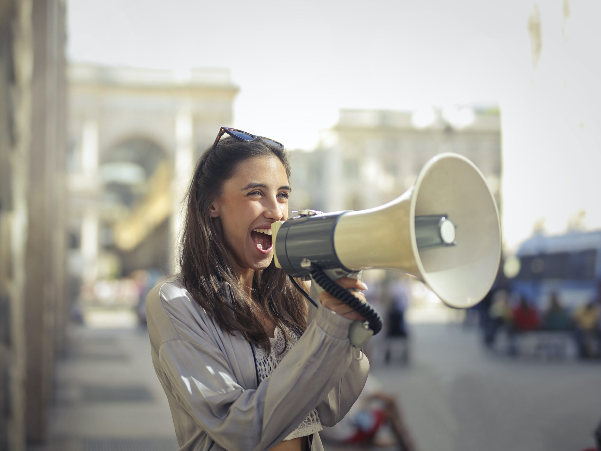 Person using a megaphone outdoors to symbolize nonprofit public relations and amplifying organizational impact.